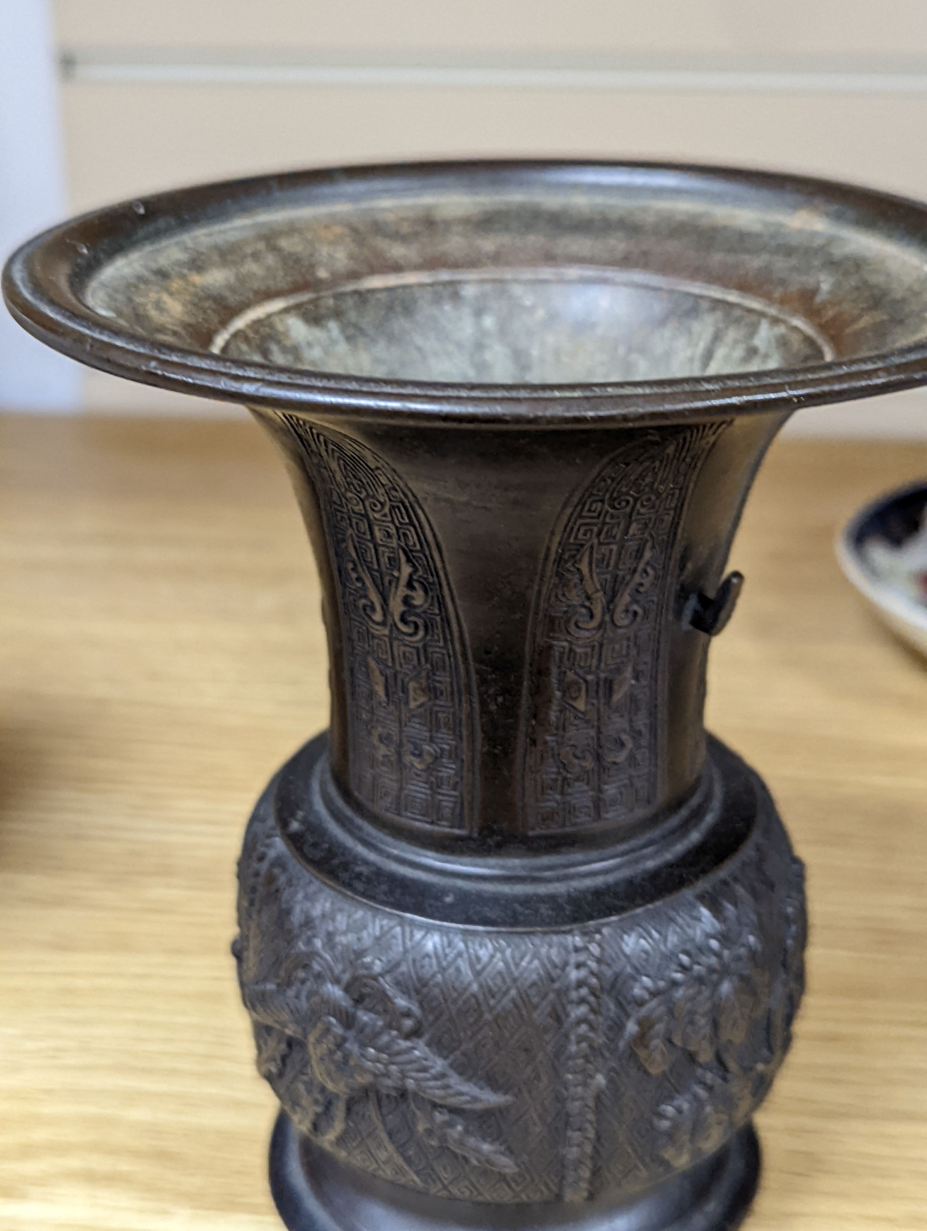 A pair of Japanese Meiji period bronze ‘dragon’ bottle vases and another, 21cm